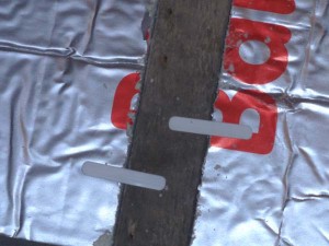 PIR thermal insulation board held with plastic clips between joists
