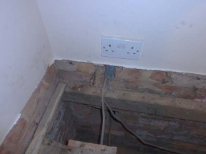 Skirting board removed to allow release of floorboards trapped underneath