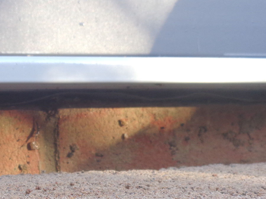 Close Up View Under Door Sill Before Sealing