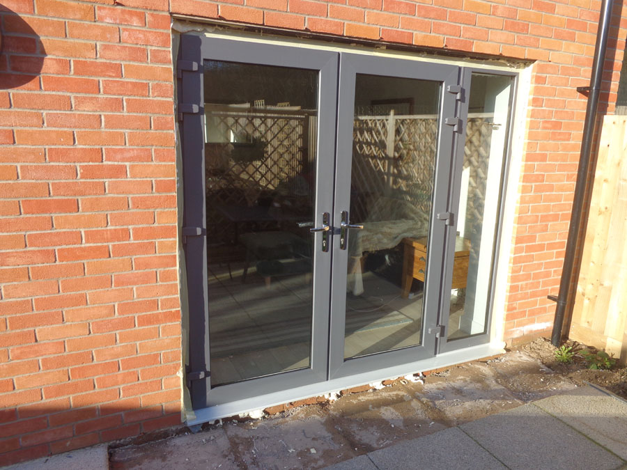 French doors re-installed with expanding foam around frame.